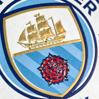 曼彻斯特城队徽特写，深蓝色背景上的帆船与玫瑰标志